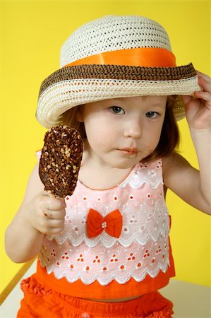 Small girl is eating chocolate ice-cream with nuts Stock Photo - Budget Royalty-Free & Subscription, Code: 400-04527551