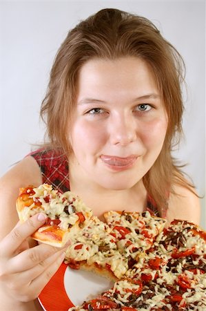 Beautiful no make-up girl eating a piece of Pizza Stock Photo - Budget Royalty-Free & Subscription, Code: 400-04527580
