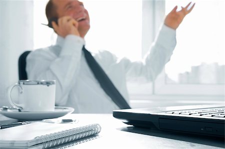 simsearch:400-04180586,k - Blurred portrait of young businessman in office environment.  Focused on laptop. Stockbilder - Microstock & Abonnement, Bildnummer: 400-04527698