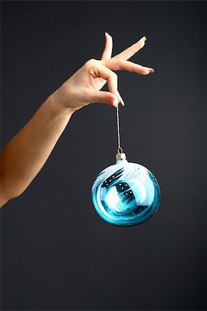 The girl hand gives the new year ball on a black background Stock Photo - Budget Royalty-Free & Subscription, Code: 400-04527870