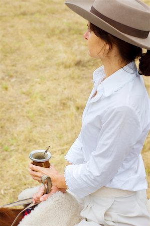 simsearch:400-04529072,k - A young Argentinean gaucha relaxing with yerba mate while riding her horse. Stock Photo - Budget Royalty-Free & Subscription, Code: 400-04529070