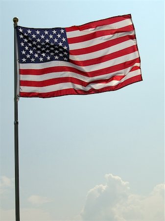 simsearch:622-02621533,k - waving united states of america flag, clear light blue sky in background, small clouds in the bottom Stock Photo - Budget Royalty-Free & Subscription, Code: 400-04529253