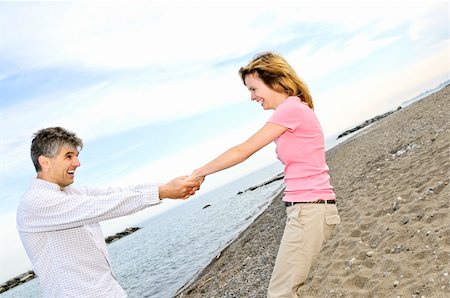 Mature romantic couple having fun on a beach Stock Photo - Budget Royalty-Free & Subscription, Code: 400-04529610