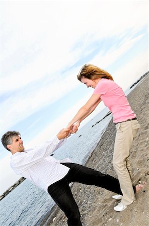 Mature romantic couple having fun on a beach Stock Photo - Budget Royalty-Free & Subscription, Code: 400-04529611