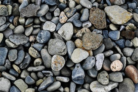 rosliothman (artist) - Multiple shapes and sizes of pebbles on the beach Foto de stock - Super Valor sin royalties y Suscripción, Código: 400-04529917