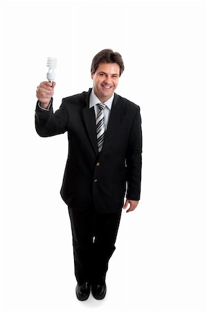 Eco friendly energy ideas for business.   A smiling businessman in a suit holding up an energy efficient compact flourescent light bulb. Stockbilder - Microstock & Abonnement, Bildnummer: 400-04520157