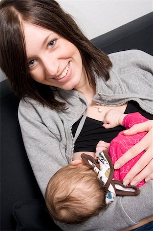 young mother on a sofa with their baby girl Stock Photo - Budget Royalty-Free & Subscription, Code: 400-04520638