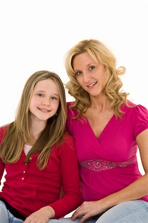 Mother and daughter setting on a white background together in casual clothing Stock Photo - Budget Royalty-Free & Subscription, Code: 400-04520964