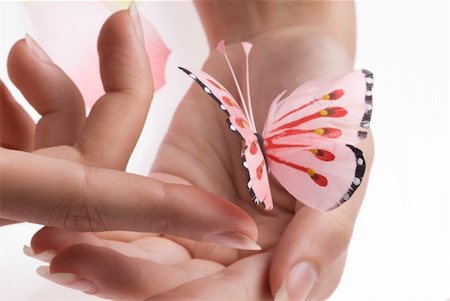 woman hands playing with finger with a pink buttrfly Foto de stock - Super Valor sin royalties y Suscripción, Código: 400-04521571