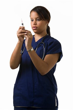 simsearch:400-03995908,k - Young attractive African American  woman healthcare worker wearing dark blue scrubs and a stethoscope holding and looking at a syringe Stock Photo - Budget Royalty-Free & Subscription, Code: 400-04522579