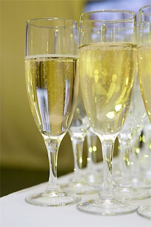 simsearch:400-05286682,k - Some glasses with a white sparkling wine stand on the brink of a table Stock Photo - Budget Royalty-Free & Subscription, Code: 400-04522948