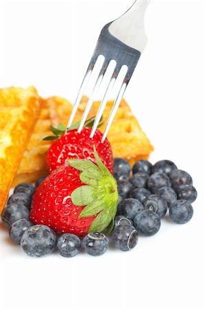 simsearch:400-08110674,k - Waffles, blueberries and the fork pricking the strawberry on white background. Shallow depth of field Stockbilder - Microstock & Abonnement, Bildnummer: 400-04522977