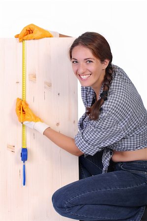 female builders carpentry - woman carpenter with wooden plank and measuring tape Stock Photo - Budget Royalty-Free & Subscription, Code: 400-04534145