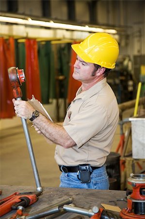 simsearch:400-04032937,k - Safety inspector checking the funtionality of tools in a metal working shop.  Authentic and accurate content depiction. Photographie de stock - Aubaine LD & Abonnement, Code: 400-04534354