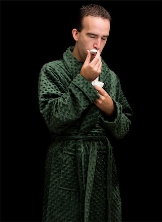 dragon_fang (artist) - A young man taking his temperature and wearing a bathrobe Stock Photo - Budget Royalty-Free & Subscription, Code: 400-04534514