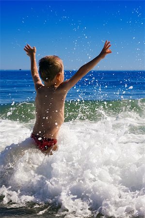 young child playing in the waves Stock Photo - Budget Royalty-Free & Subscription, Code: 400-04534683