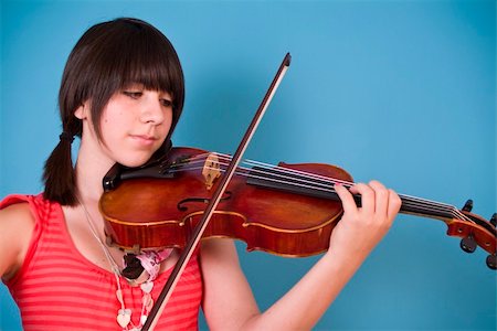 An adolescent girl practicing on her viola. Stock Photo - Budget Royalty-Free & Subscription, Code: 400-04535275