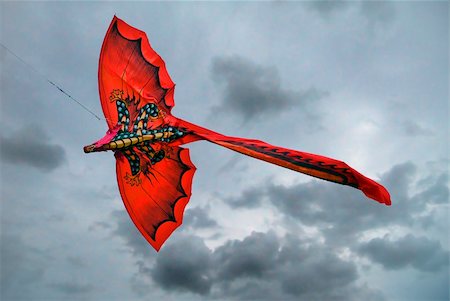 floating building in china - brilliant red dragon kite flying under grey skies Stock Photo - Budget Royalty-Free & Subscription, Code: 400-04535393