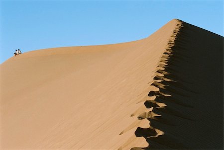 desert footsteps lost - Two people riding a camel across desert, hoofprints in foregroun Stock Photo - Budget Royalty-Free & Subscription, Code: 400-04535447