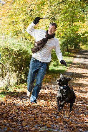 Man exercising dog in autumn woodland Stock Photo - Budget Royalty-Free & Subscription, Code: 400-04535464