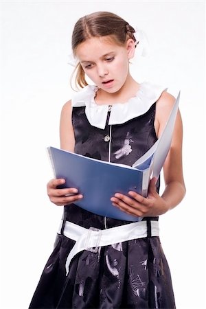 school result - Surprised pretty schoolgirl reading a copybook Stock Photo - Budget Royalty-Free & Subscription, Code: 400-04535833