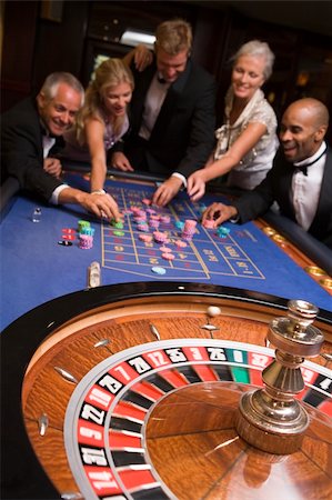 Group of friends gambling at roulette table in casino Stock Photo - Budget Royalty-Free & Subscription, Code: 400-04535851