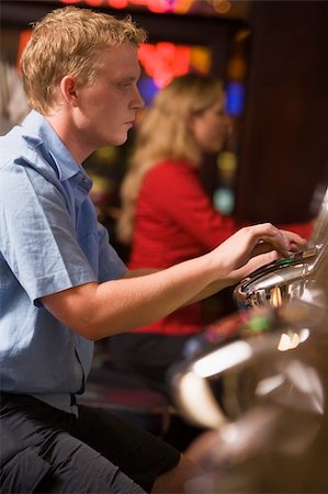 Man playing slot machines in casino Stock Photo - Budget Royalty-Free & Subscription, Code: 400-04535900