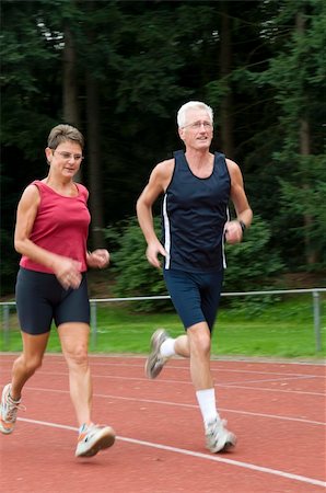 senior couple running on a race track Fotografie stock - Microstock e Abbonamento, Codice: 400-04536200