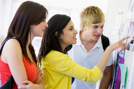 reading notice board - College students looking at a bulletin board Stock Photo - Budget Royalty-Free & Subscription, Code: 400-04536216