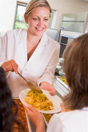 simsearch:400-04036581,k - Lunchlady serving plate of lunch in school cafeteria Stock Photo - Budget Royalty-Free & Subscription, Code: 400-04536435