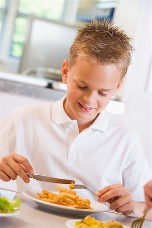 Schoolboy enjoying his lunch in a school cafeteria Stock Photo - Budget Royalty-Free & Subscription, Code: 400-04536440