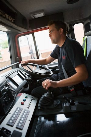 fireman driver pictures - Firefighters on their way to an emergency scene Stock Photo - Budget Royalty-Free & Subscription, Code: 400-04536487