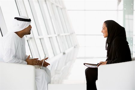 simsearch:400-04037075,k - A Middle Eastern man and woman talking at a business meeting Stock Photo - Budget Royalty-Free & Subscription, Code: 400-04536809