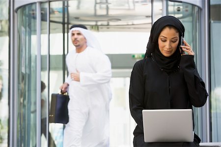 A Middle Eastern business woman sitting with a laptop Stock Photo - Budget Royalty-Free & Subscription, Code: 400-04536803