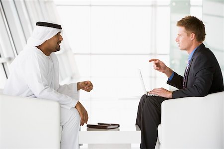 simsearch:400-04037075,k - A Middle Eastern man and a caucasian man talking at a business m Stock Photo - Budget Royalty-Free & Subscription, Code: 400-04536811