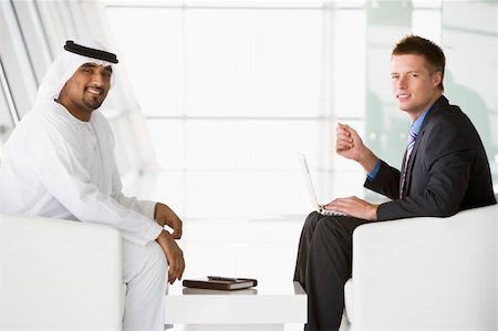 simsearch:400-04037075,k - A Middle Eastern man and a caucasian man talking at a business m Stock Photo - Budget Royalty-Free & Subscription, Code: 400-04536812