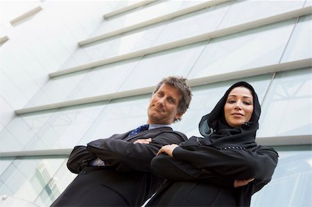 A Middle Eastern businesswoman and a Caucasian businessman smili Stock Photo - Budget Royalty-Free & Subscription, Code: 400-04536829