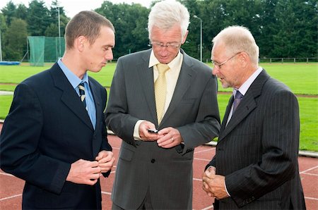 Businessmen discussing their business on a race track. Fotografie stock - Microstock e Abbonamento, Codice: 400-04536875