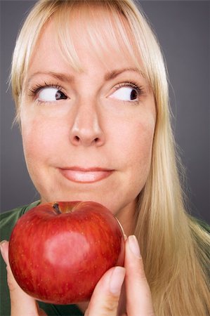 simsearch:400-04042499,k - Beautiful Woman With Apple Against A Grey Background Stock Photo - Budget Royalty-Free & Subscription, Code: 400-04537547