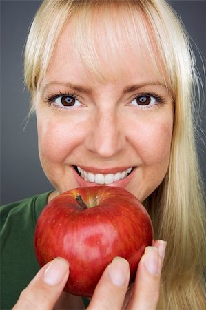 simsearch:400-04042499,k - Beautiful Woman With Apple Against A Grey Background Stock Photo - Budget Royalty-Free & Subscription, Code: 400-04537548