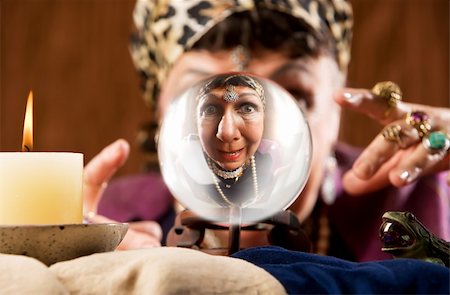smiling bank teller - Female gypsy fortune teller looking into a crystal ball Stock Photo - Budget Royalty-Free & Subscription, Code: 400-04537642