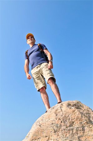 simsearch:400-08506088,k - Middle aged hiker standing on top of a mountain Fotografie stock - Microstock e Abbonamento, Codice: 400-04538148