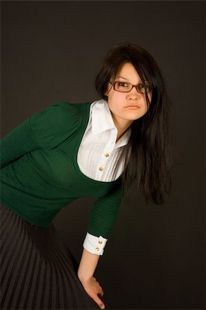 Serious looking girl dresses as teacher or businesswoman isolated on black Stock Photo - Budget Royalty-Free & Subscription, Code: 400-04538210