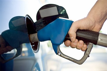 close-up of a mens hand refilling the car with a gas pump Stock Photo - Budget Royalty-Free & Subscription, Code: 400-04538223