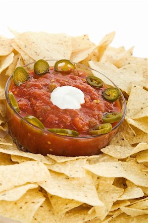 simsearch:400-07994495,k - Closeup of a bowl of salsa nestled in a ring of tortilla chips, garnished with sour cream and jalapeno slices. Stock Photo - Budget Royalty-Free & Subscription, Code: 400-04538314