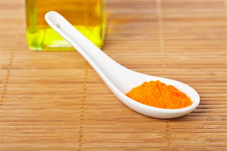 simsearch:400-04047920,k - Saffron in the spoon and oil bottle for prepare tasty food with soft shadow in the bamboo mat background. Shallow depth of field Stock Photo - Budget Royalty-Free & Subscription, Code: 400-04538416