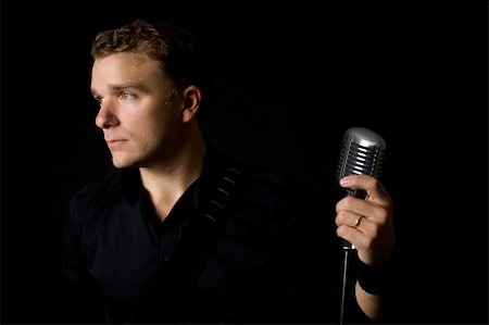 portrait of young musician holding his microphone Foto de stock - Super Valor sin royalties y Suscripción, Código: 400-04538792