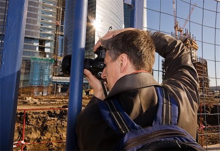 Mature photographer at work photographing construction area Stock Photo - Budget Royalty-Free & Subscription, Code: 400-04538810
