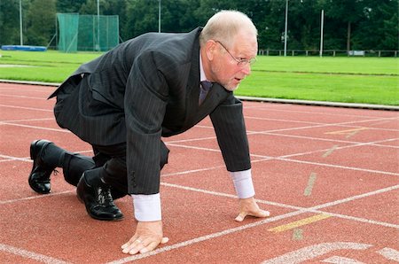 Businessman is ready for the start of his run. Stockbilder - Microstock & Abonnement, Bildnummer: 400-04539100