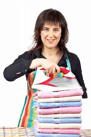 simsearch:400-04019890,k - A housewife in apron holding a eletric iron close to towels stacked Stock Photo - Budget Royalty-Free & Subscription, Code: 400-04539134